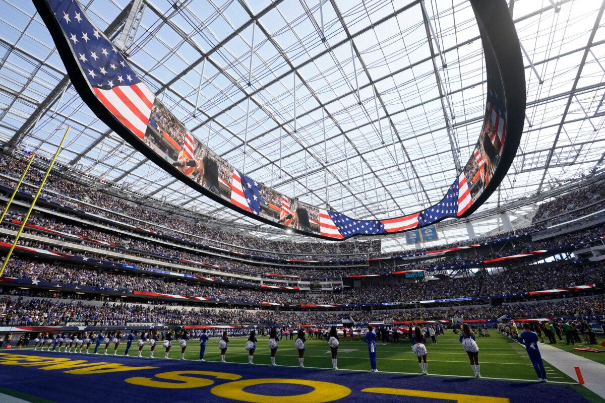 Cheerleaders and players stand for the American national anthem before an NFL football game between the Los Angeles Rams and the Pittsburgh Steelers at SoFi Stadium in Inglewood, Calif., on Oct. 22, 2023. (Gregory Bull/AP Photo)