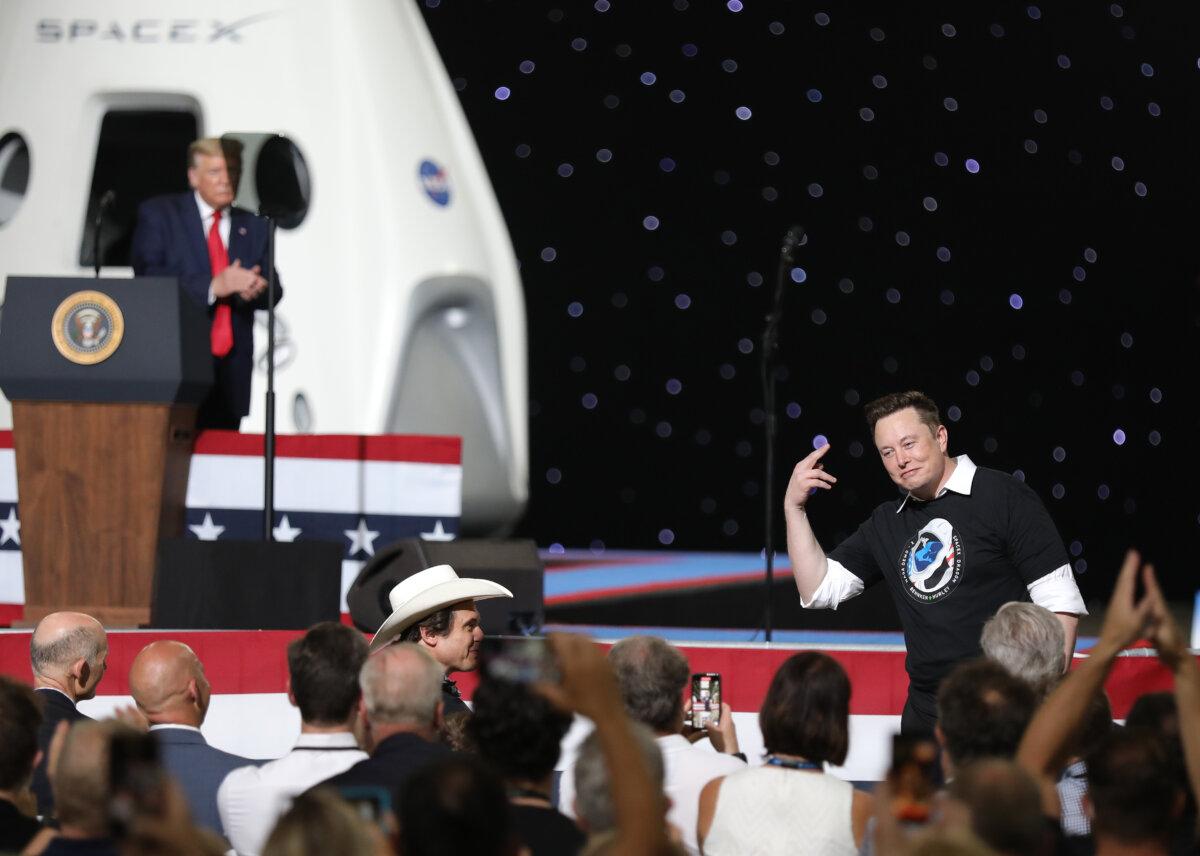 Then-President Donald Trump acknowledges Spacex founder Elon Musk (R) after the successful launch of the SpaceX Falcon 9 rocket with the manned Crew Dragon spacecraft at the Kennedy Space Center in Cape Canaveral, Florida, on May 30, 2020. (Joe Raedle/Getty Images)