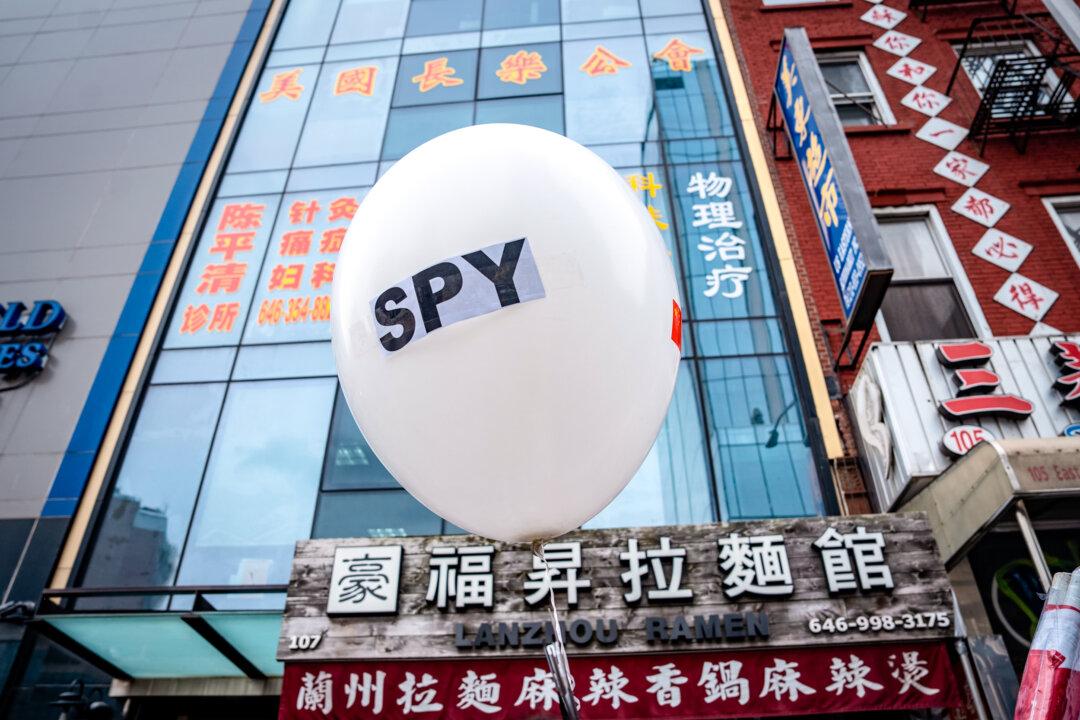 A balloon is held at a press conference in front of the America ChangLe Association highlighting Beijing's transnational repression, in New York City on Feb. 25, 2023. A now-closed overseas Chinese police station is located inside the association building. (Samira Bouaou/The Epoch Times)