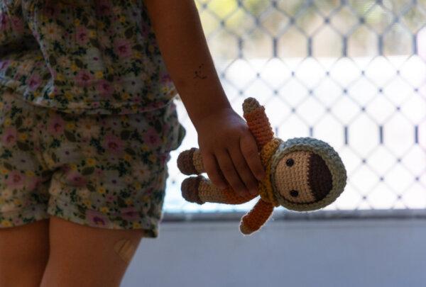 Becca, 5, who has been diagnosed with Alice in Wonderland Syndrome, looks out her window in the Los Angeles area in California on Aug. 13, 2024. (John Fredricks/The Epoch Times)