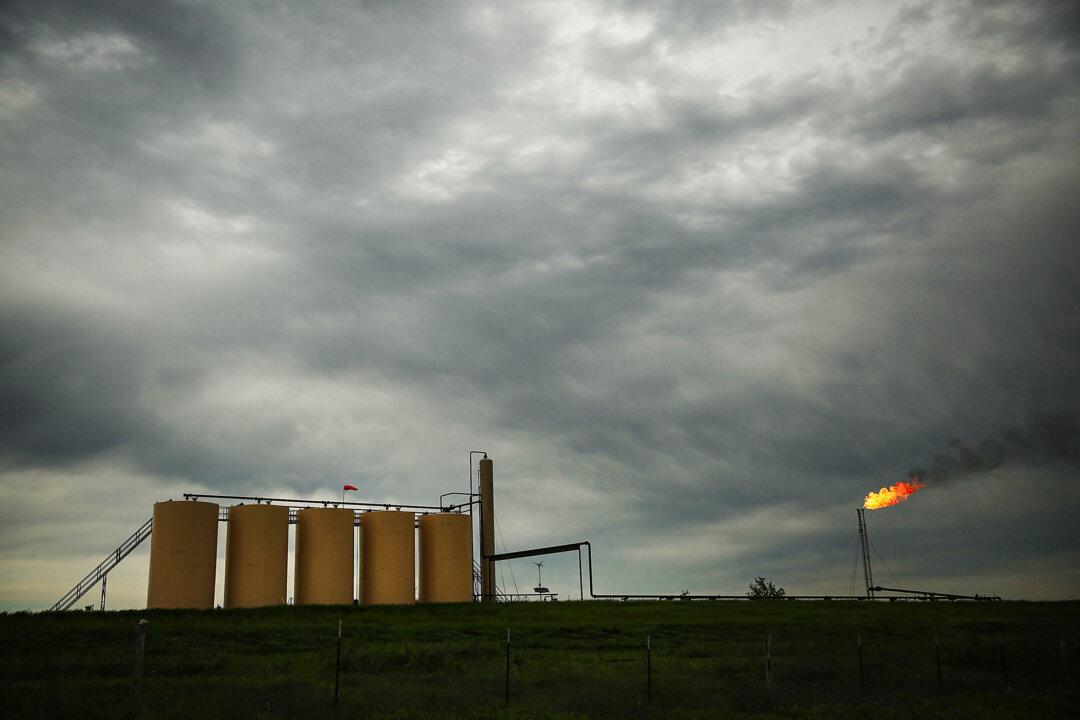 Natural gas is flared off at a plant outside of the town of Cuero, Texas, on March 26, 2015. The U.S. Energy Information Administration reported that natural gas consumption set new records every month between March and November 2023. (Spencer Platt/Getty Images)