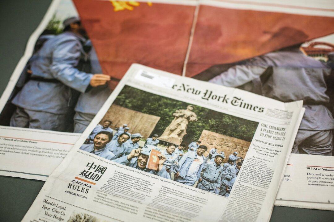 The New York Times published a section called “China Rules” in its Nov. 25, 2018, edition. The section included giant Chinese characters on a red background and a glowing report on the Chinese Communist Party, while simultaneously criticizing the United States. (Samira Bouaou/The Epoch Times)