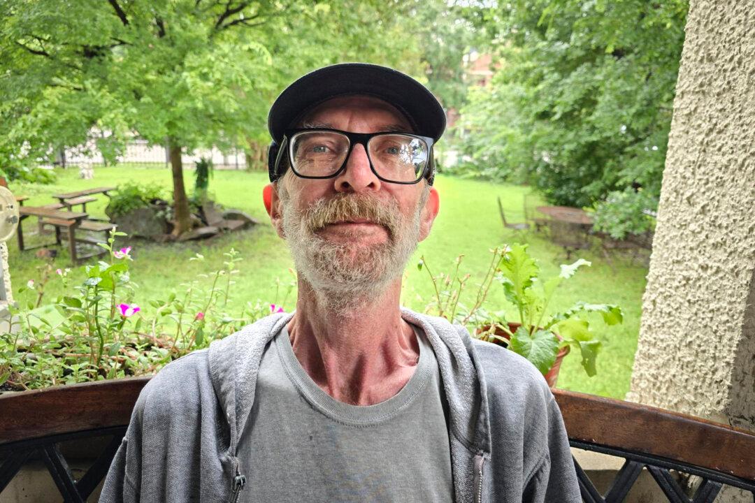 Magnificat Houses assistant group home leader James, 66, sits on the bench on the front porch on July 26, 2024. (Allan Stein/The Epoch Times)