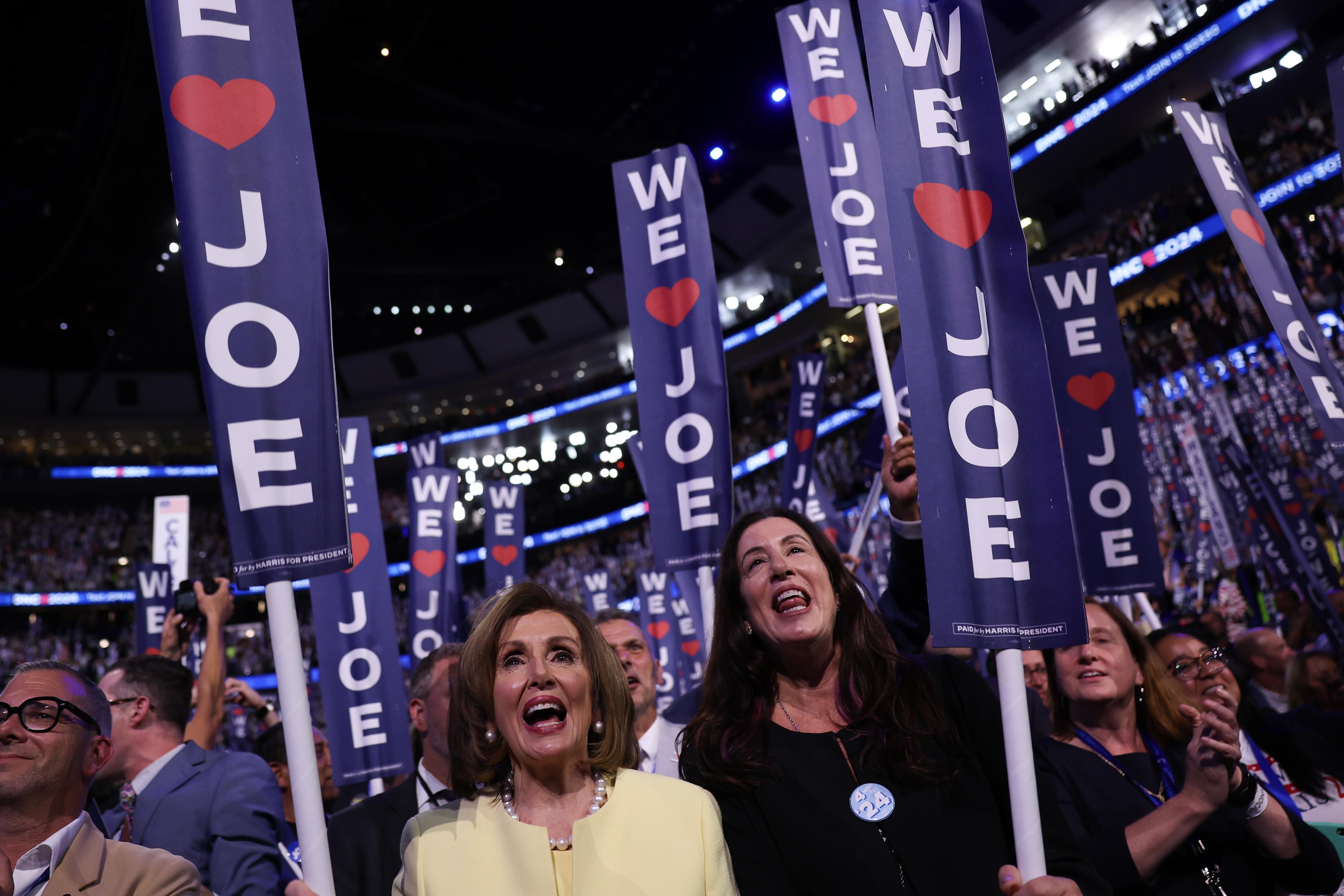 Speaker Emerita Nancy Pelosi holds a Joe Biden sign during the first day of the Democratic National Convention at the United Center in Chicago, Ill., on Aug.19, 2024. (Justin Sullivan/Getty Images)