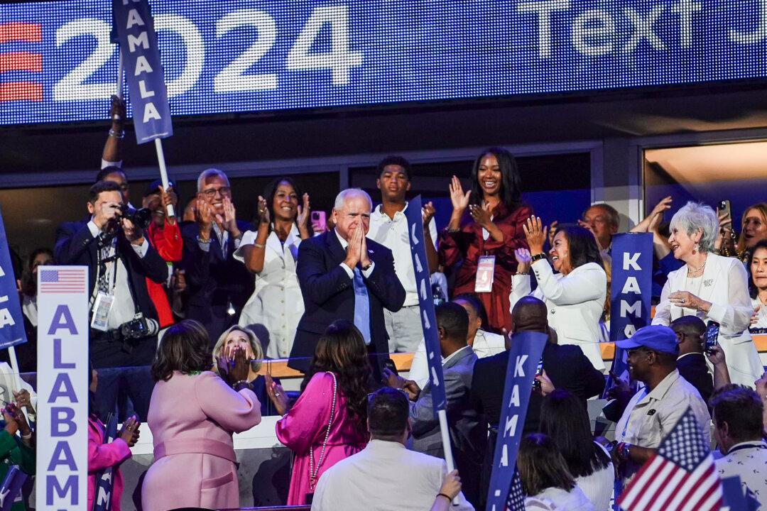 Democratic vice presidential candidate Minnesota Gov. Tim Walz reacts to Democratic presidential candidate, Vice President Kamala Harris, coming onstage on the last day of the Democratic National Convention in Chicago on Aug. 22, 2024. (Madalina Vasiliu/The Epoch Times)