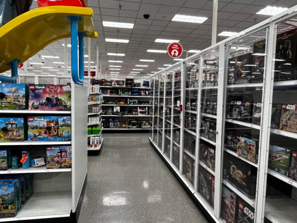 Lego sets with locks (L) and other Legos behind locked glass doors in the Target store in Colma, Calif., on Aug. 20, 2024. (Dylan Morgan/The Epoch Times)