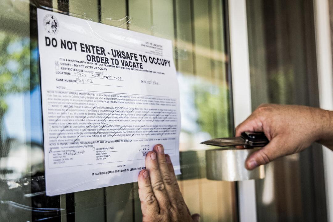 A vacate order is taped to the window of the site. (John Fredricks/The Epoch Times)