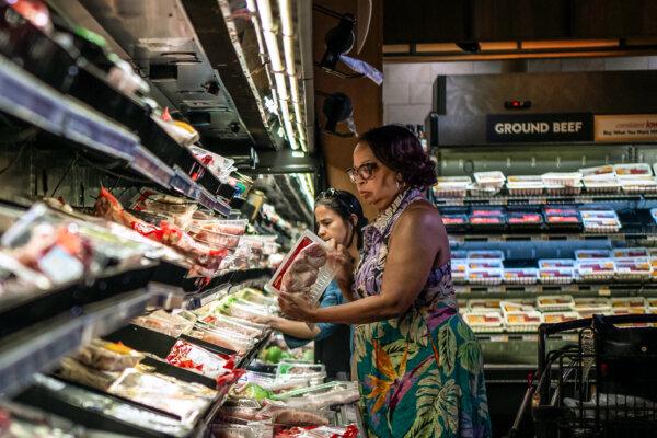 People shop in the meat section of a grocery store in Columbia, Md., on June 8, 2024. (Madalina Vasiliu/The Epoch Times)