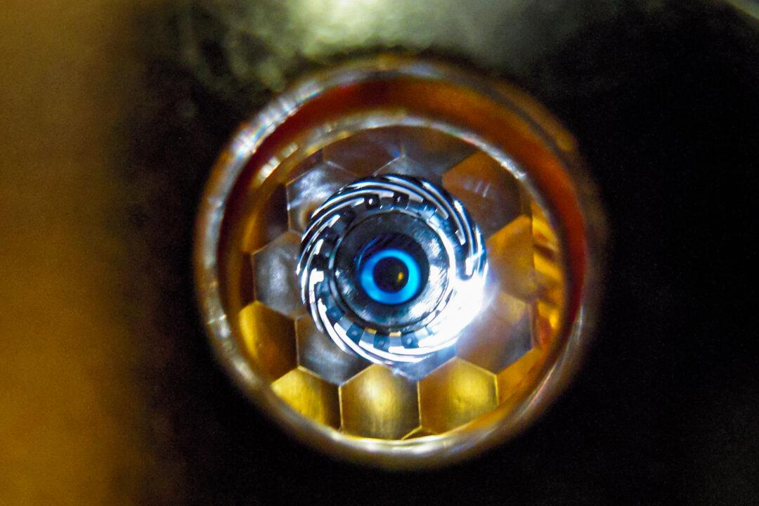 (Top) Technicians work on a target (R) at the National Ignition Facility (NIF) at Lawrence Livermore National Laboratory. (Bottom L) An illustrative rendering shows a NIF target pellet inside a hohlraum capsule with laser beams entering through the openings on both end. The beams compress and heat the target to the necessary conditions for nuclear fusion to occur. (Bottom R) A view of the cryogenically cooled target as seen by the laser through the hohlraum capsule's laser entrance point. (U.S. Department of Energy)