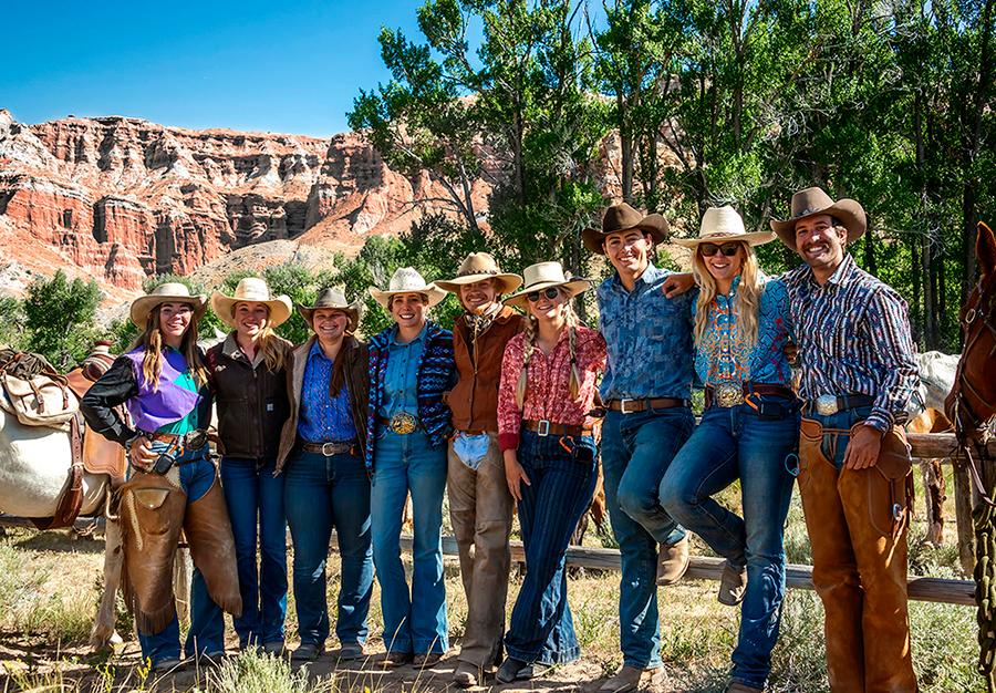 Wranglers stand by coral at the breakfast ride cookout: Victoria Lilly, 28; Hannah Blasdell, 17; Jami Brophy, 23; Skylar Keiss, 22; Levi Moses, 25: Taylor Heimbigner, 23; Joseph Mowad, 18; Nell Barbour, 24; and Sam Hubert, 24. (Maria Coulson)