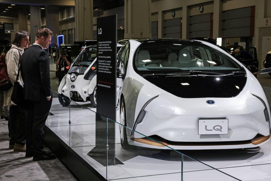 Attendees check out the Toyota LQ and i-Road battery electric vehicles during a preview at the Washington DC Auto Show in Washington on Jan. 19, 2023. (Alex Wong/Getty Images)