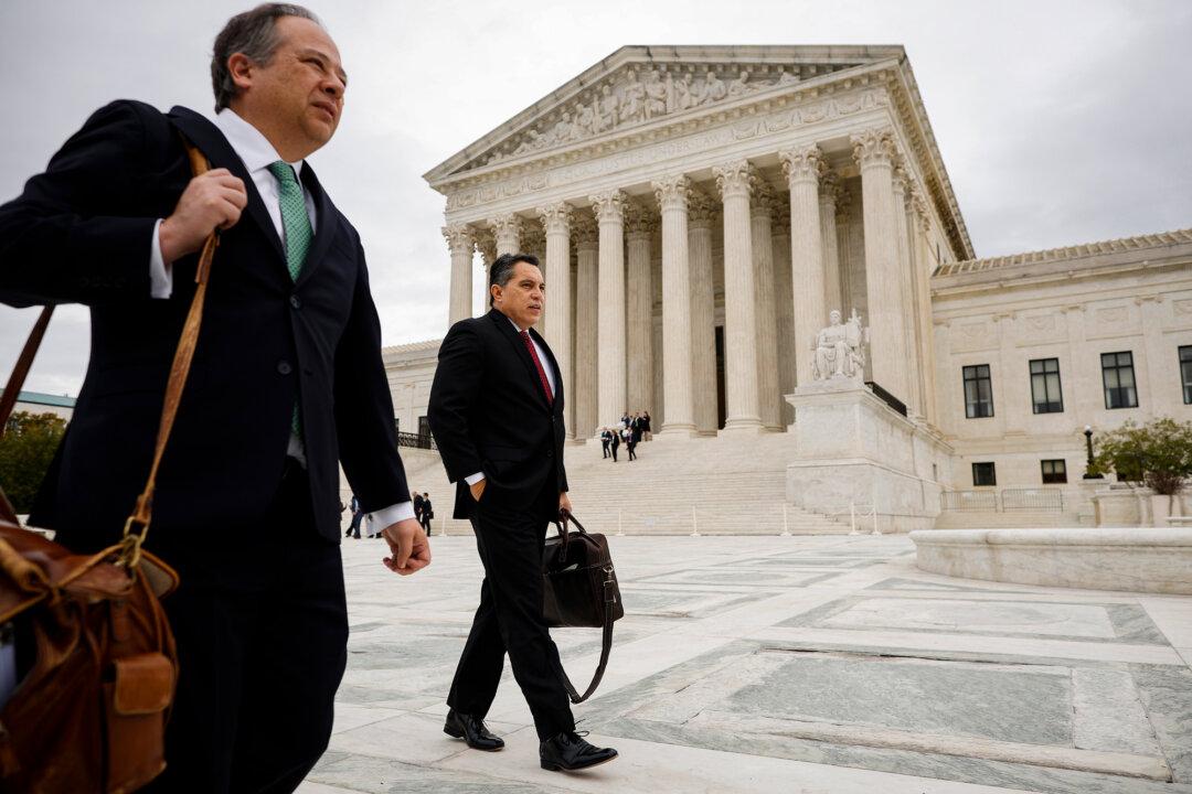 Attorney David Hinojosa (R) leaves the U.S. Supreme Court after oral arguments in Washington on Oct. 31, 2022. The court in the 2022 case of Students for Fair Admissions v. Harvard ruled that any universities that receive government funding cannot discriminate in their admissions criteria. (Chip Somodevilla/Getty Images)