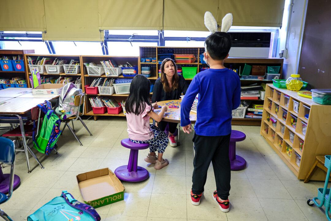 A teacher talks with students at Yung Wing School P.S. 124 in New York City on June 24, 2022. (Michael Loccisano/Getty Images)