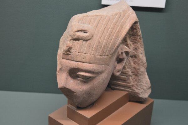 A red sandstone fragment of a statue of Tutankhamun. (Keegan Billings/The Epoch Times)