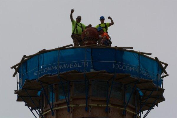 Restoration experts from ICC Commonwealth show their enthusiasm from the top of the lighthouse tower. (Courtesy of Karen Gough)