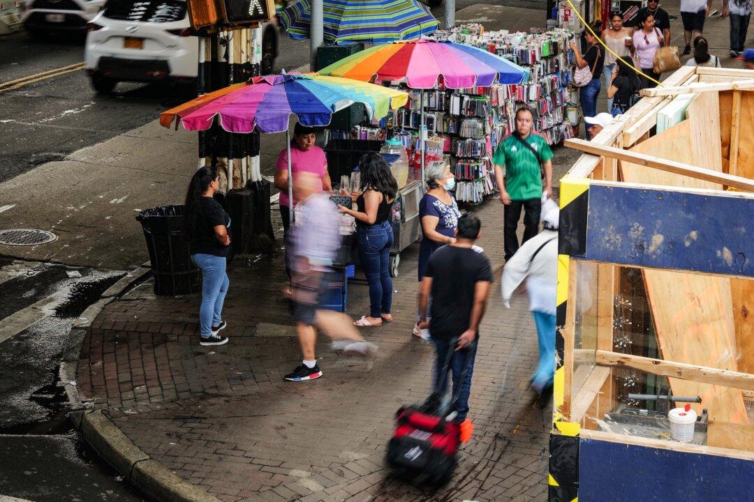 A street vendor sells products along Roosevelt Avenue in Queens, an area with a high number of recent illegal immigrants in New York City on Aug. 16, 2023. (Spencer Platt/Getty Images)