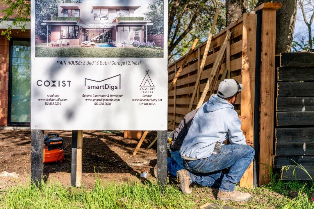 Workers renovate the exterior of a newly constructed home in Austin, Texas, on March 19, 2024. (Brandon Bell/Getty Images)