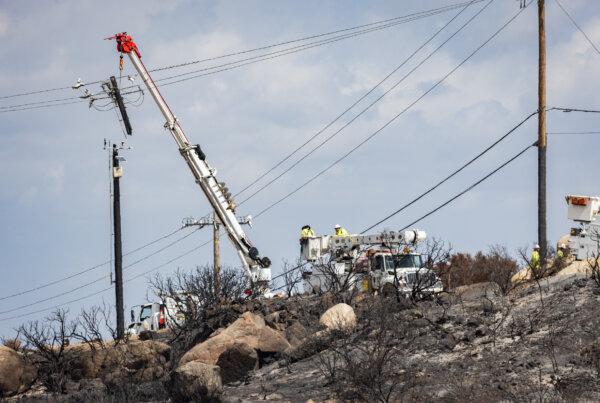 Workers fix powerlines destroyed by the Airport Fire in El Cariso Village, Calif., on Sep. 16, 2024. (John Fredricks/The Epoch Times)