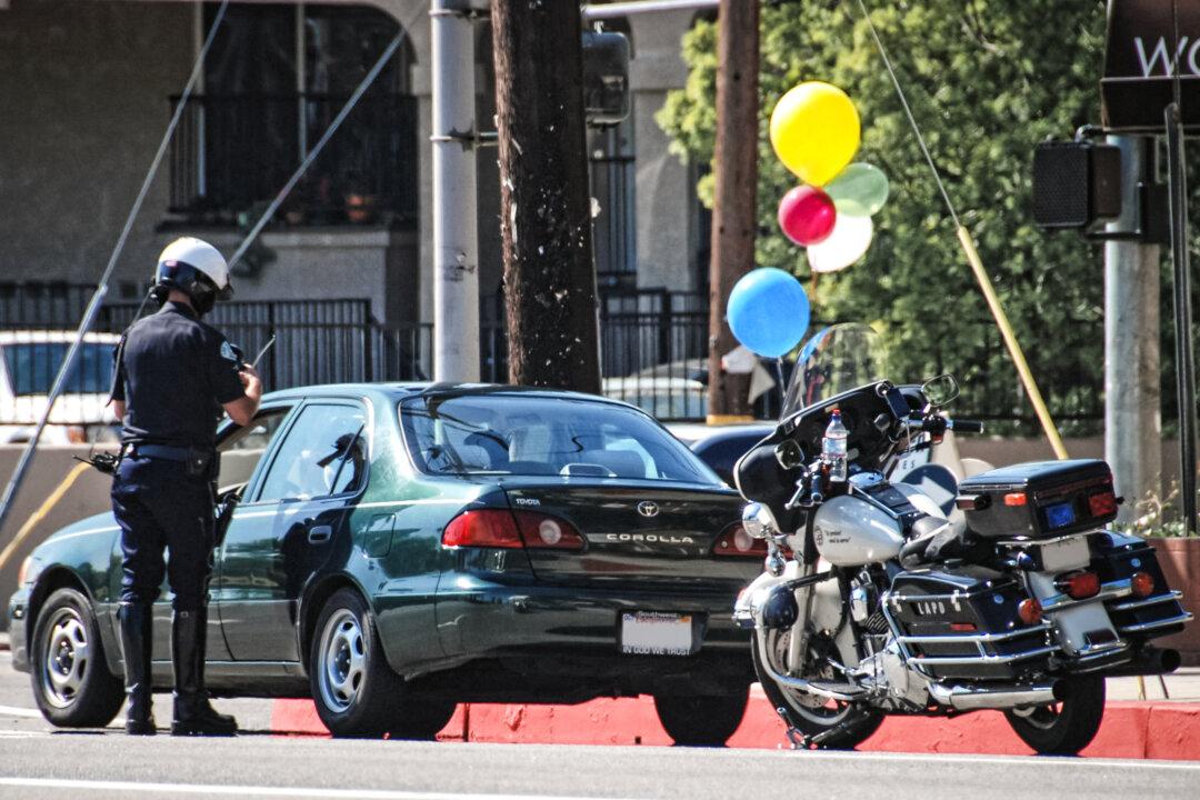 A Los Angeles Police Department officer stops a vehicle in the Arleta neighborhood of Los Angeles, in this file photo. (Chris Yarzab/Flickr)