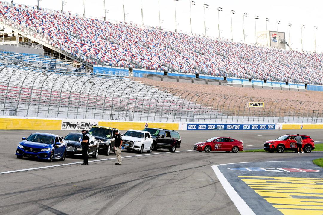 Graduating students and their families line up on a racetrack in vehicles during a commencement ceremony held at Las Vegas Motor Speedway in Las Vegas on May 22, 2020. (Ethan Miller/Getty Images)