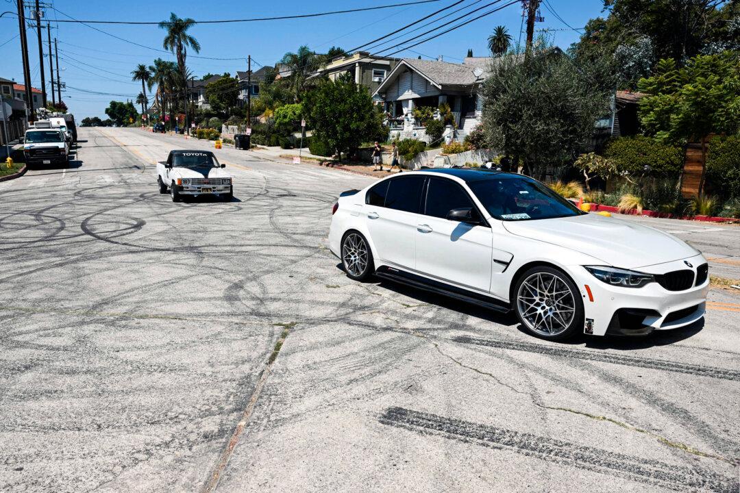 Vehicles drive over tire skid marks from other drivers doing burnouts and donuts on Bellevue Ave. as area residents protest an increase in street racing takeovers and the latest Fast and Furious movie being filmed in the Angelino Heights neighborhood of Los Angeles on Aug. 26, 2022. (Patrick T. Fallon/AFP via Getty Images)