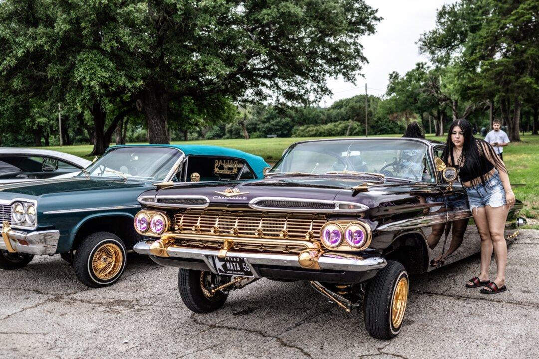 Mariah Mata (R), daughter of Dallas Lowriders spokesperson Mark Mata, starts a car in Kiest park in Dallas, Texas, on June 2, 2024. (Andrew Caballero-Reynolds/AFP via Getty Images)