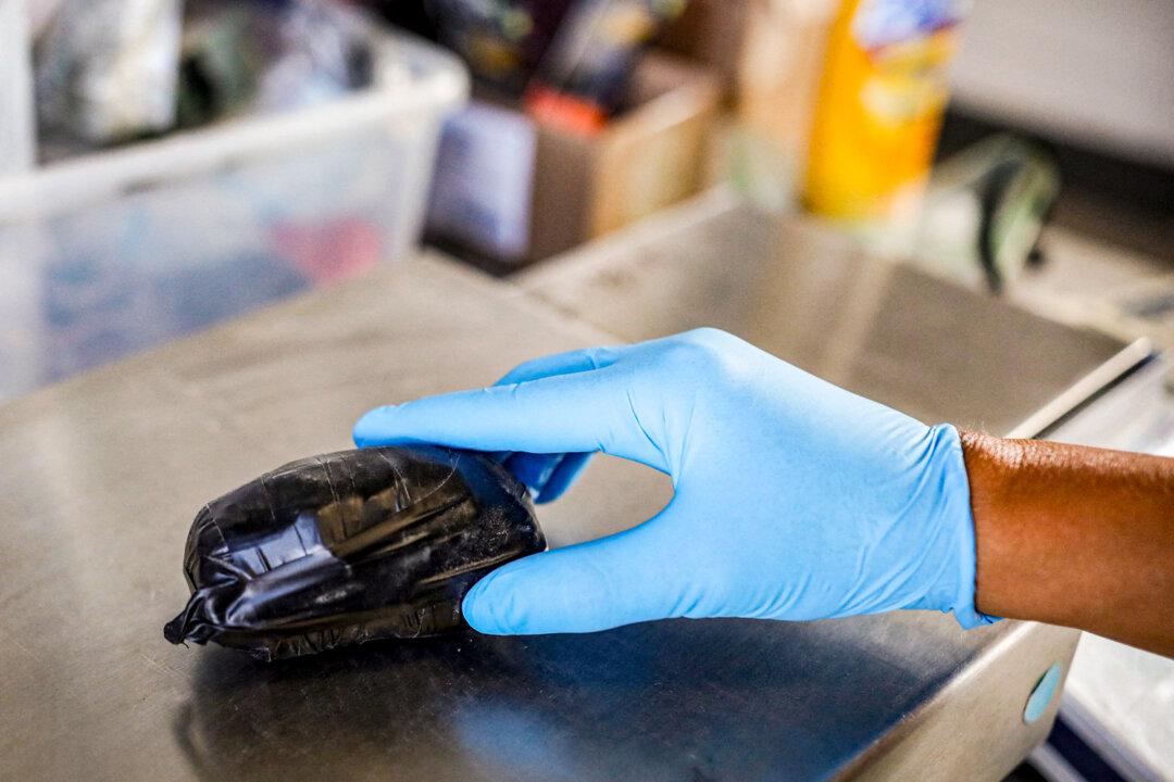 A U.S. Customs and Border Protection agent weighs a package of fentanyl at the San Ysidro Port of Entry in San Ysidro, Calif., on Oct. 2, 2019. (Sandy Huffaker/AFP via Getty Images)