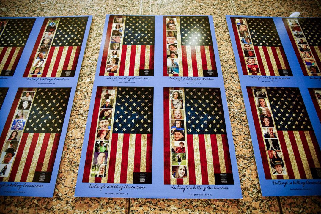 Photos of Americans who died from fentanyl overdose are displayed at the Drug Enforcement Administration headquarters in Arlington, Va., on July 13, 2022. (Agnes Bun/AFP via Getty Images)