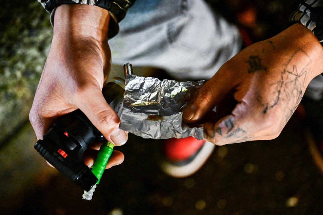 (Top) A person lies on the street after the decriminalization of all drugs, in the Old Town Chinatown neighborhood in Portland, Ore., on Jan. 25, 2024. (Bottom Left) A used Narcan brand naloxone nasal spray lies on the street after paramedics and police respond to a suspected fentanyl drug overdose in Portland, Ore., on Jan. 25, 2024. (Bottom Right) A person uses fentanyl following the decriminalization of all drugs, in downtown Portland, Ore., on Jan. 23, 2024. (Patrick T. Fallon/AFP via Getty Images)