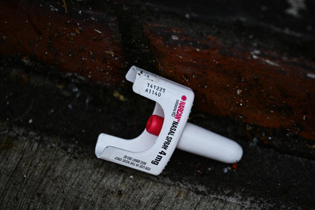 (Top) A person lies on the street after the decriminalization of all drugs, in the Old Town Chinatown neighborhood in Portland, Ore., on Jan. 25, 2024. (Bottom Left) A used Narcan brand naloxone nasal spray lies on the street after paramedics and police respond to a suspected fentanyl drug overdose in Portland, Ore., on Jan. 25, 2024. (Bottom Right) A person uses fentanyl following the decriminalization of all drugs, in downtown Portland, Ore., on Jan. 23, 2024. (Patrick T. Fallon/AFP via Getty Images)