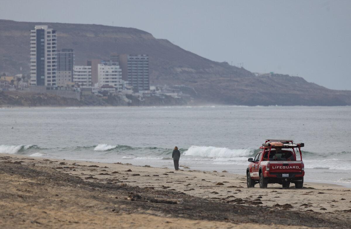 A lifeguard drives toward the Tijuana River mouth outside of San Diego on Sept. 19, 2024. (John Fredricks/The Epoch Times)