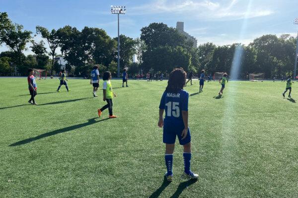 Children play football at the 5 Star Soccer Academy, run by Honduran footballer Nahun Romero, in the Queens borough of New York City on May 20, 2024. Romero, a Honduran footballer who arrived in New York City penniless and undocumented, is living his American dream in the Big Apple where he leads a successful football school. Romero's academy, with its hundreds of hopeful kids, might have been unimaginable for the Honduran second flight player, who was in New York working construction full time by day and playing football full time by night. (Photo by Thomas URBAIN / AFP) (Photo by THOMAS URBAIN/AFP via Getty Images)