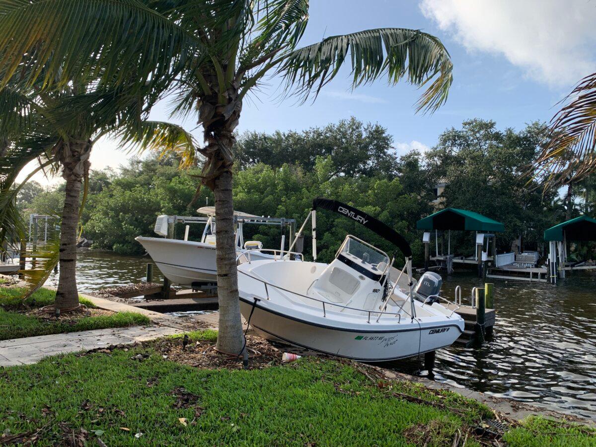 A boat is stuck to the dock after breaking loose during record storm surge in Tampa Bay, Fla., on Sept. 27, 2024. (T.J. Muscaro/The Epoch Times)