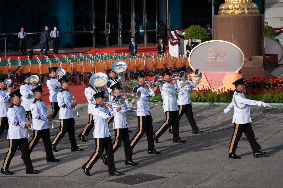 Hong Kong Police Guard of Honour marches with the flags of China and Hong Kong during a flag-raising ceremony to celebrate communist China's 75th anniversary at Golden Bauhinia Square in Hong Kong on Oct. 1, 2024. (Anthony Kwan/Getty Images)