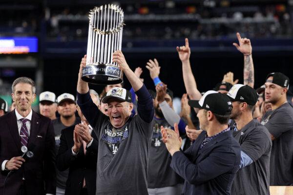 Stan Kasten, President and CEO of the Los Angeles Dodgers, celebrates with the Commissioner's Trophy after defeating the New York Yankees 7–6 in Game Five to win the 2024 World Series at Yankee Stadium in New York on Oct. 30, 2024. (Elsa/Getty Images)