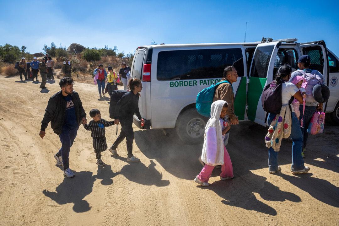 Border Patrol agents take asylum seekers into custody after they crossed a remote part of the U.S.-Mexico near Jacumba Hot Springs, California, on Sept. 19, 2024. (John Moore/Getty Images)