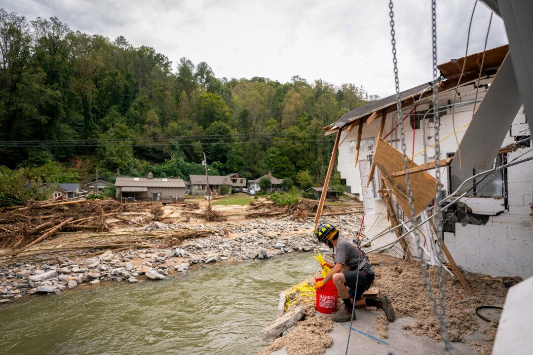 Avery Sherrill salvages what he can from his destroyed family business, Mudtools, along the Broad River in the aftermath of Hurricane Helene in Bat Cave, North Carolina on Oct. 1, 2024. (Sean Rayford/Getty Images)