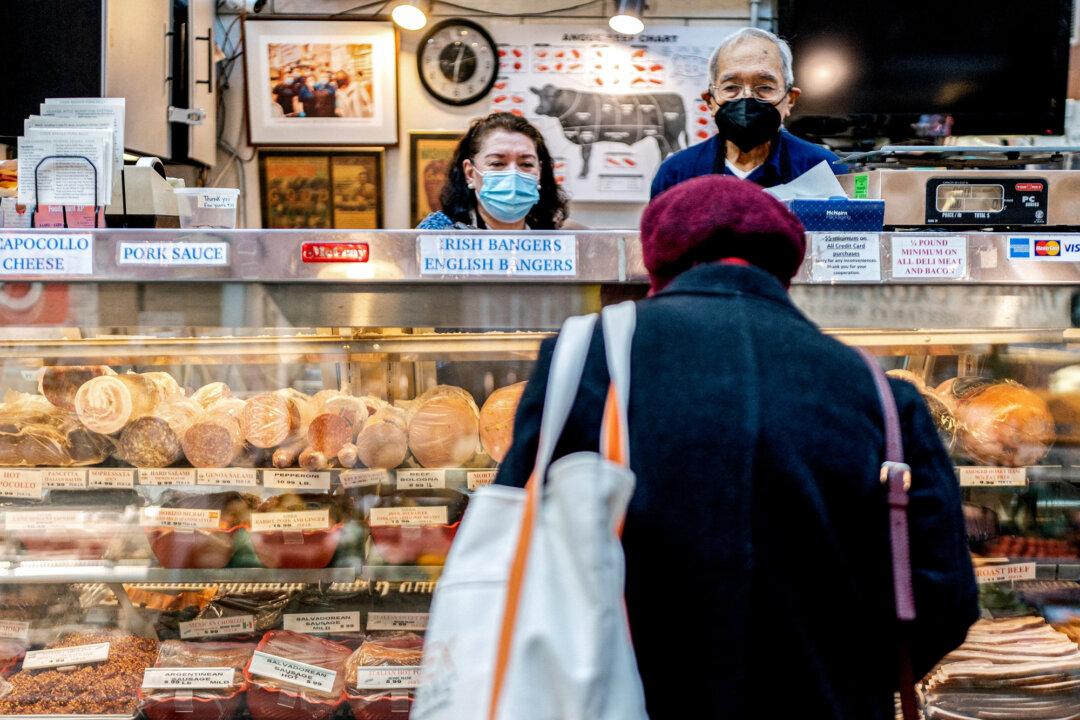 Employees assist a customer at Canales Quality Meats in Washington on Feb. 8, 2022. The EPA said it expects minor impact on prices and the supply of meat and poultry, but industry insiders said they worry the impact will be more significant than the EPA calculated. (Stefani Reynolds/AFP via Getty Images)