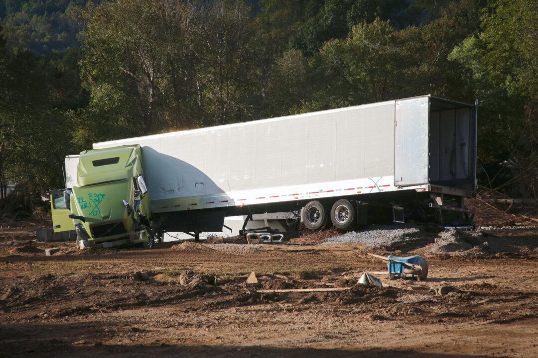 A wrecked truck stranded in a bed of mud in Swannanoa, N.C., on Oct. 2, 2024. (Richard Moore/The Epoch Times)