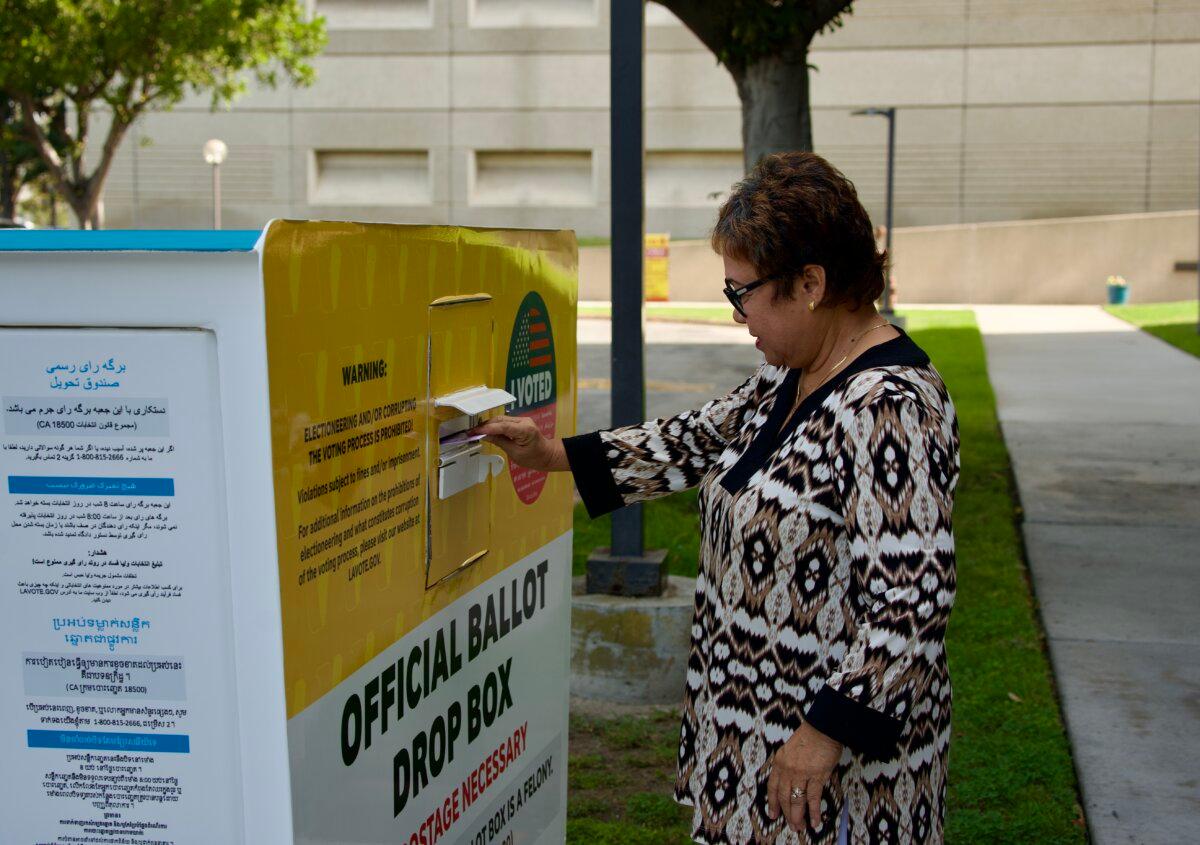 A voter places her ballot into a voting ballot drop box at the Los Angeles County Registrar-Recorder/County Clerk in Norwalk, Calif., on Oct. 7, 2024. (Sophie Li/The Epoch Times)