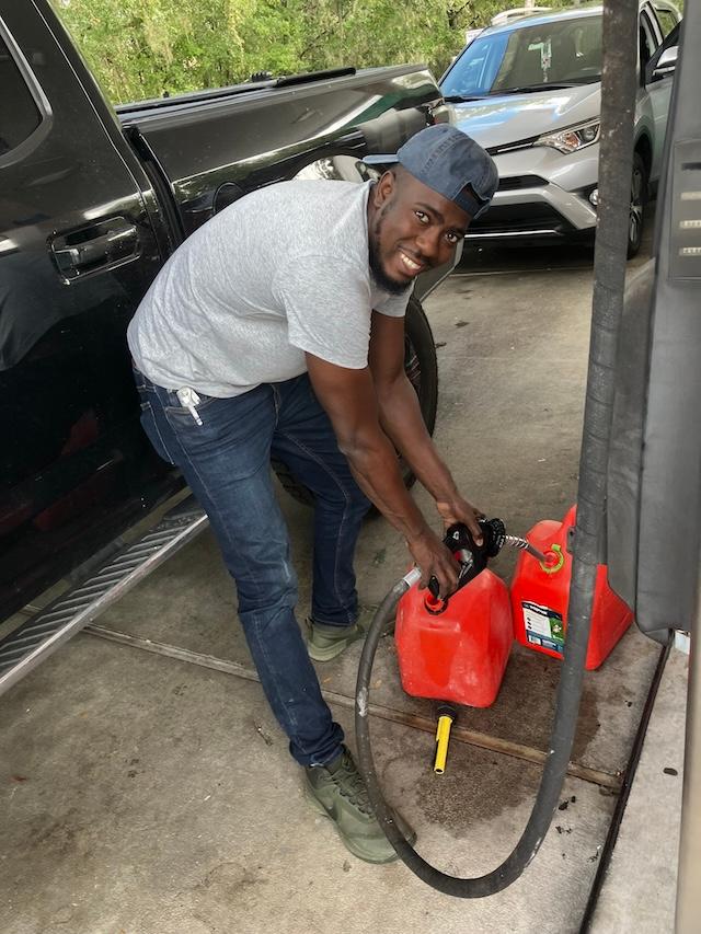 Shane Bucknor fills gas containers ahead of Hurricane Milton at a gas station in South Lakeland on Oct. 8, 2024. (John Haughey/The Epoch Times)