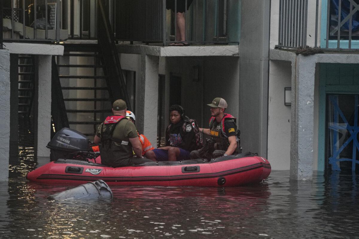 Residents are rescued from an their second story apartment complex in Clearwater that was flooded from and overflowing creek due to Hurricane Milton on Oct. 10, 2024 in Florida. (Bryan R. Smith/AFP via Getty Images)