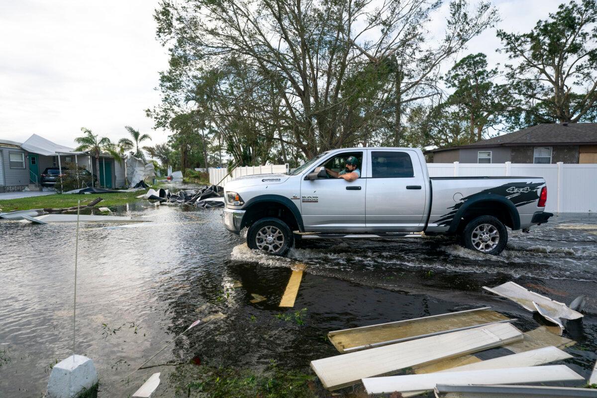 A motorist drives through a flooded street in the aftermath of Hurricane Milton in Osprey, Fla., on Oct. 10, 2024. (Sean Rayford/Getty Images)