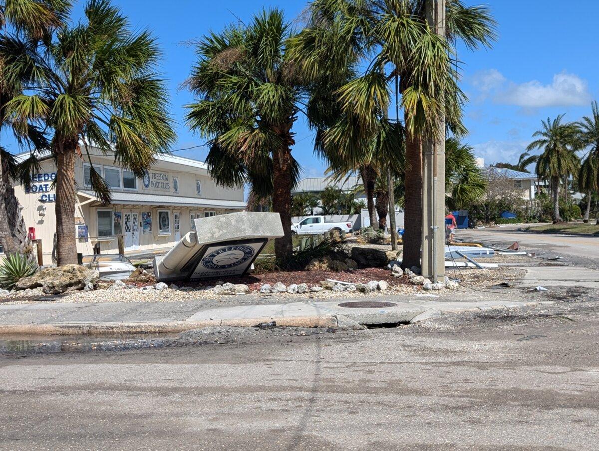 The Freedom Boat Club sign at the corner of Tarpon Center Drive and The Esplanade in Venice, Florida, is seen laying on its side in the aftermath of Hurricane Milton on Oct. 10, 2024. (Jacob Burg/The Epoch Times)