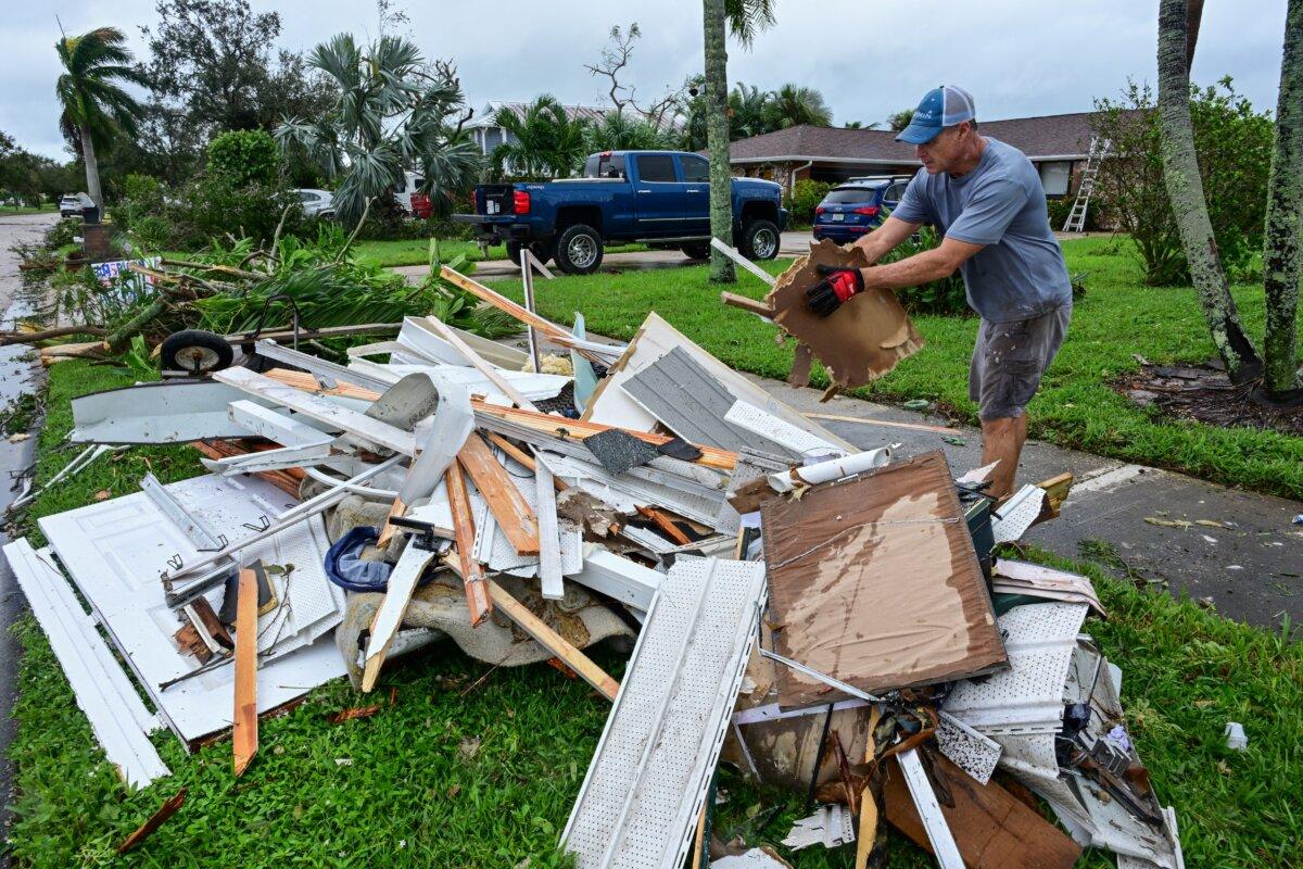 A man collects debris caused by a tornado in Cocoa Beach, Fla., on Oct. 10, 2024. (Giorgio Viera/AFP via Getty Images)