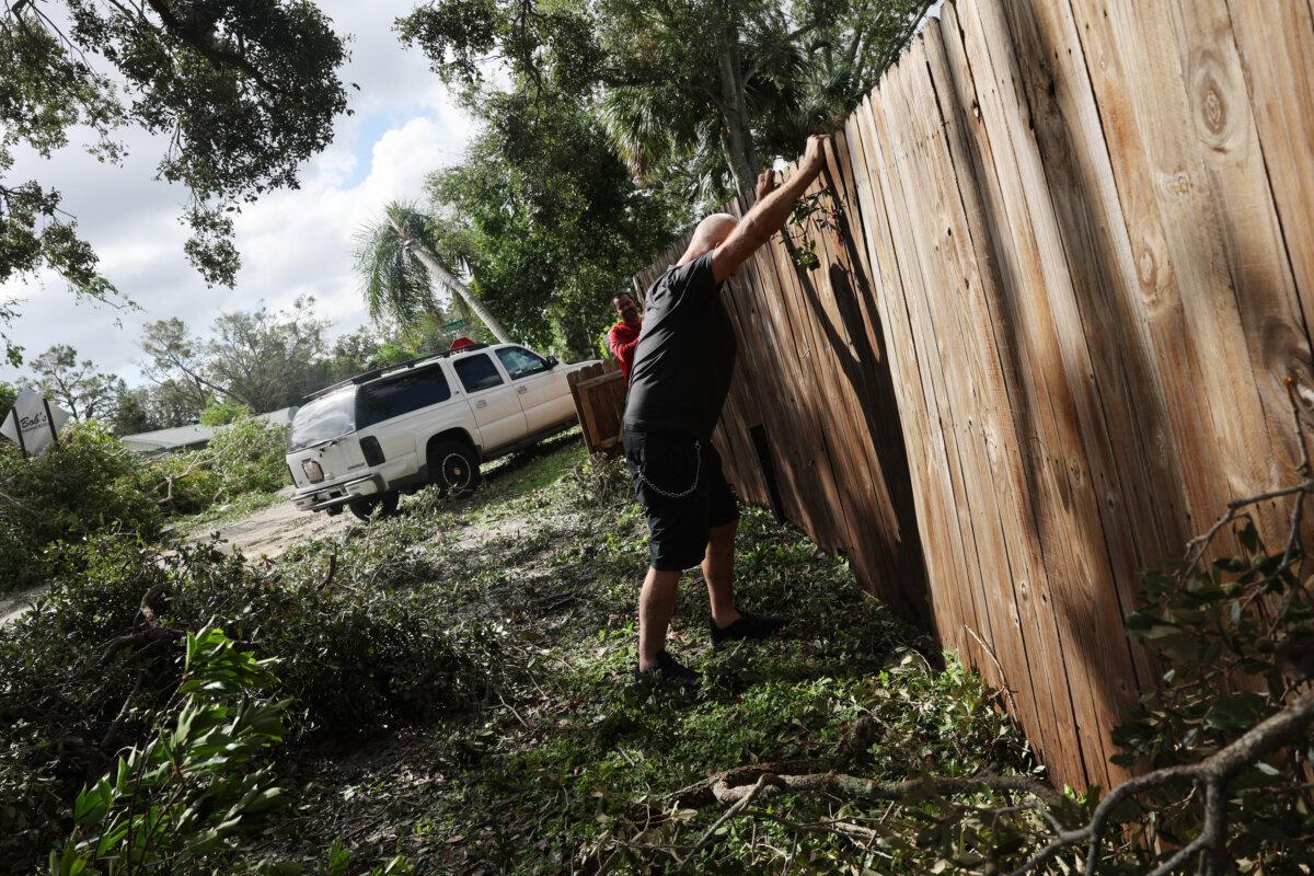 Men work on cleaning-up after the arrival of Hurricane Milton in Gulfport, Fla., on on Oct. 10, 2024. (Spencer Platt/Getty Images)