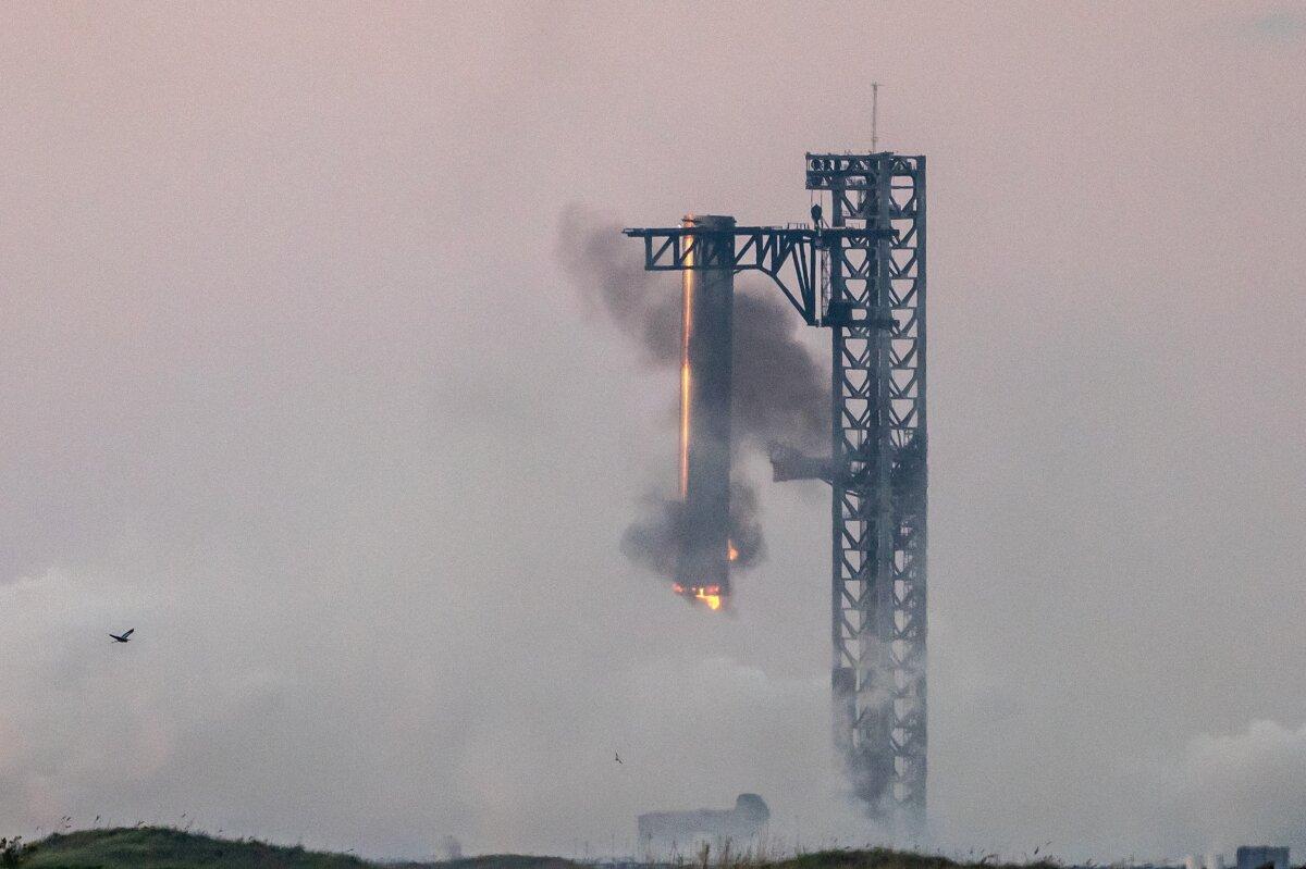 Starship's Super Heavy Booster is grappled at the launch pad in Starbase, near Boca Chica, Texas, on Oct. 13, 2024, during the Starship Flight 5 test. (Sergio Flores/AFP via Getty Images)