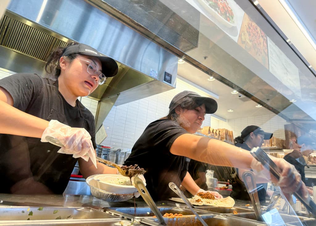 Workers fill food orders at a Chipotle restaurant in San Rafael, Calif., on April 1, 2024. (Justin Sullivan/Getty Images)