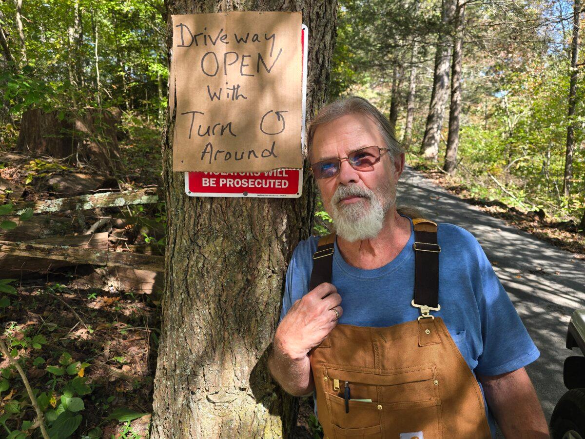 Robert Chessick, 74, of Black Mountain, N.C., stands at the end of his driveway on Oct. 8, 2024. (Allan Stein/The Epoch Times)