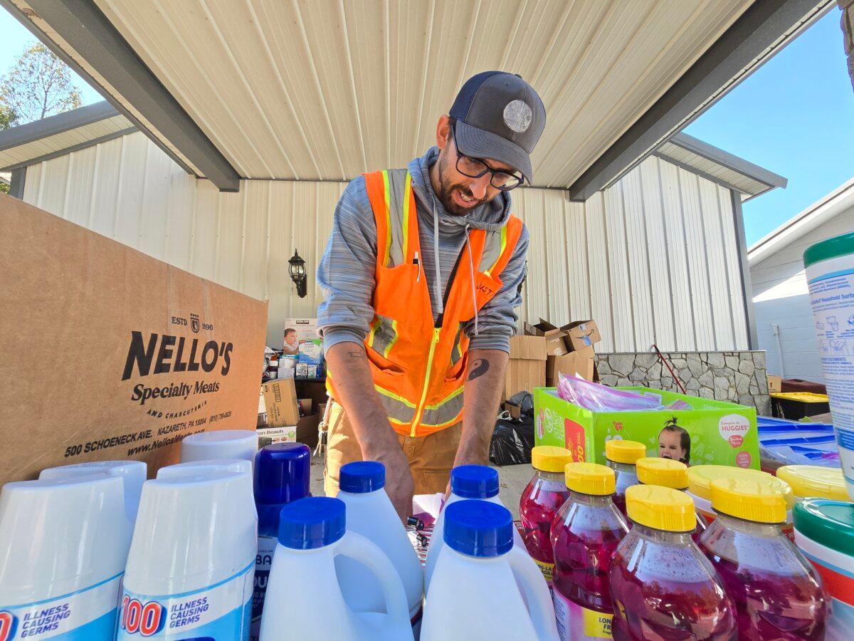 Volunteer Justin Honeywell sorts through donated items at Stone Mountain Baptist Church in Black Mountain, N.C., on Oct. 8, 2024. (Allan Stein/The Epoch Times)